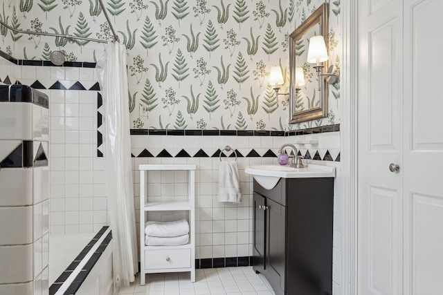 bathroom with wallpapered walls, tile walls, tile patterned floors, and vanity