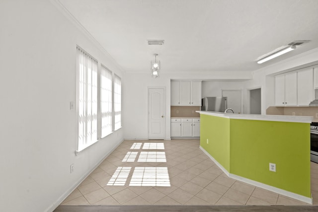 kitchen featuring white cabinets, appliances with stainless steel finishes, visible vents, light countertops, and ornamental molding