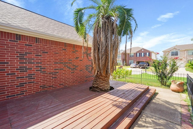 deck featuring fence and a residential view