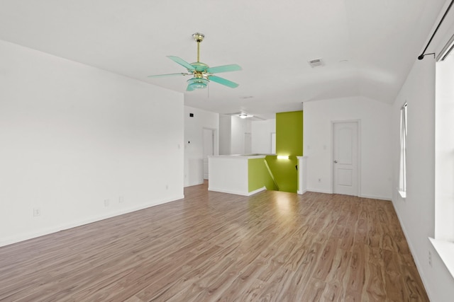 unfurnished living room with baseboards, visible vents, ceiling fan, and light wood-style flooring