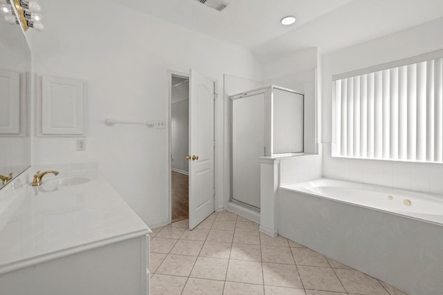full bathroom with a shower stall, tile patterned flooring, a bath, and vanity