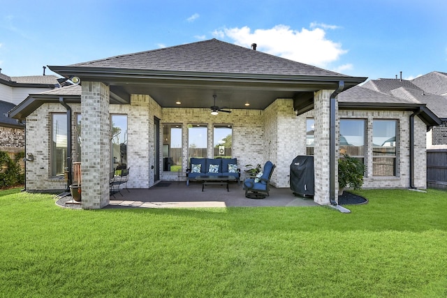 rear view of property featuring a yard, ceiling fan, a patio area, and outdoor lounge area