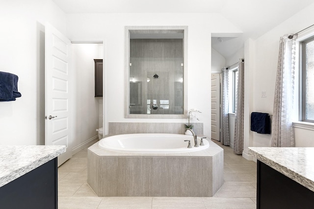 bathroom with a tile shower, tile patterned floors, vanity, a garden tub, and lofted ceiling