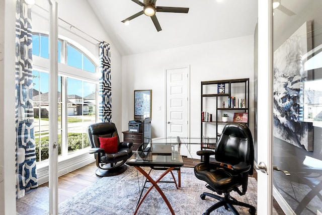 home office featuring a ceiling fan, wood finished floors, a healthy amount of sunlight, and high vaulted ceiling