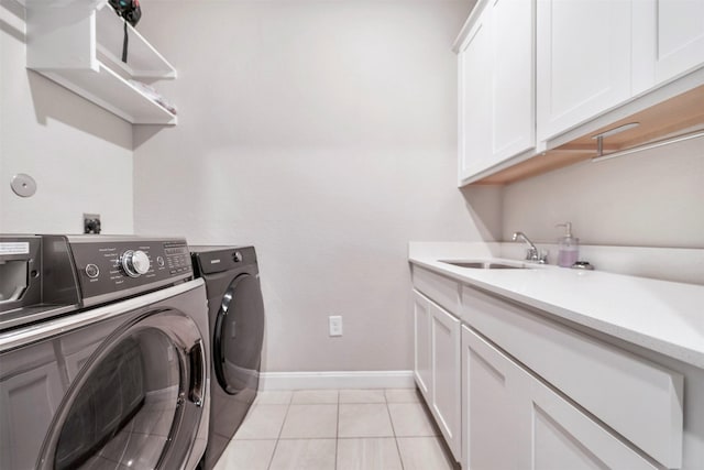 21443 Petherton Dr, Tomball, TX 77375 - washroom featuring washing machine and dryer, light tile patterned flooring, baseboards, a sink, and cabinet space