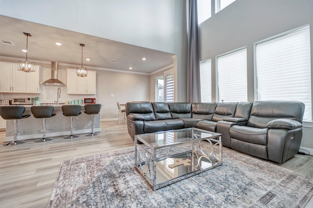 21443 Petherton Dr, Tomball, TX 77375 - living area featuring recessed lighting, baseboards, ornamental molding, and light wood-style flooring