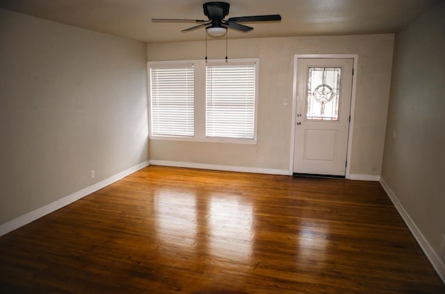 foyer featuring baseboards, wood finished floors, and a ceiling fan