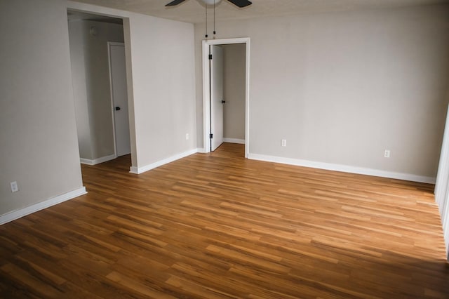 empty room featuring wood finished floors, ceiling fan, and baseboards