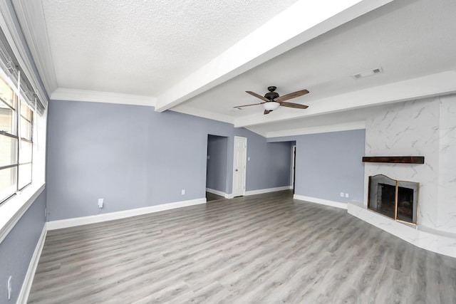 13003 Foxburo Dr, Houston, TX 77065 - unfurnished living room featuring a ceiling fan, visible vents, wood finished floors, baseboards, and a premium fireplace
