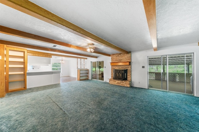 unfurnished living room with beam ceiling, a fireplace, a ceiling fan, carpet, and a textured ceiling
