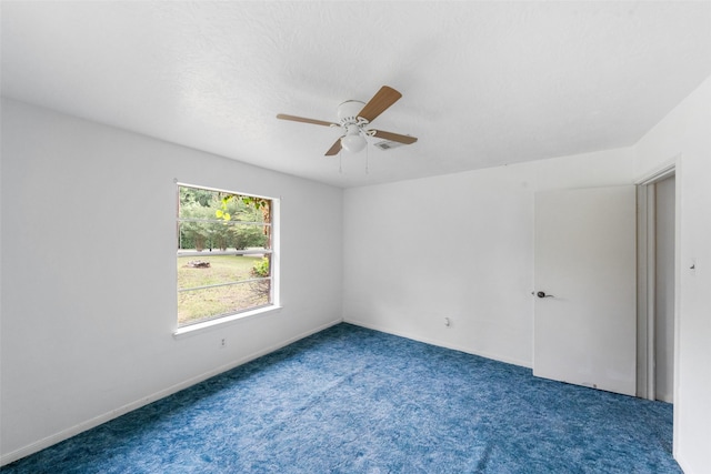 empty room with a ceiling fan, carpet floors, and baseboards