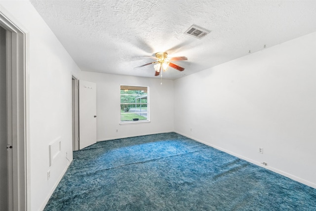 spare room with a textured ceiling, visible vents, ceiling fan, baseboards, and carpet floors
