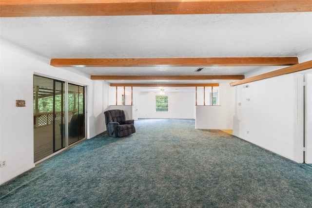 unfurnished room with a textured ceiling, visible vents, carpet floors, beam ceiling, and a ceiling fan