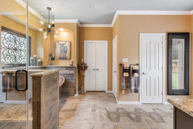 interior space with baseboards, ornamental molding, decorative light fixtures, and light stone countertops