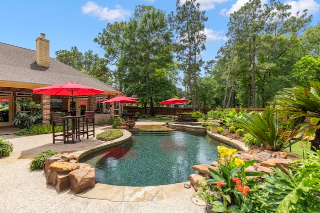 view of swimming pool featuring a fenced in pool, a fenced backyard, an in ground hot tub, and a patio area