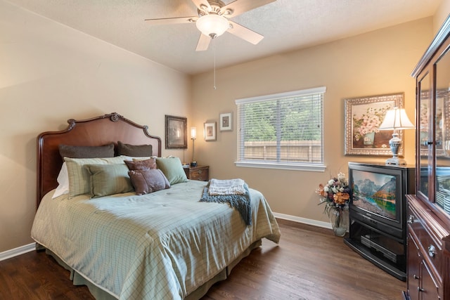 bedroom featuring baseboards, ceiling fan, and wood finished floors