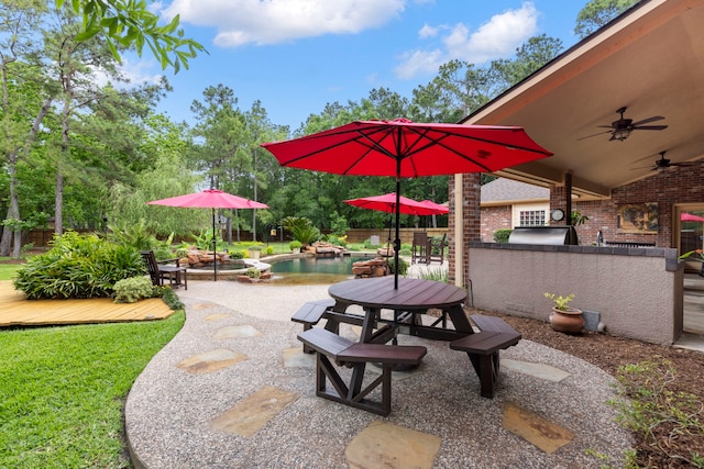 surrounding community with a wooden deck, fence, outdoor dining area, a pool, and a lawn