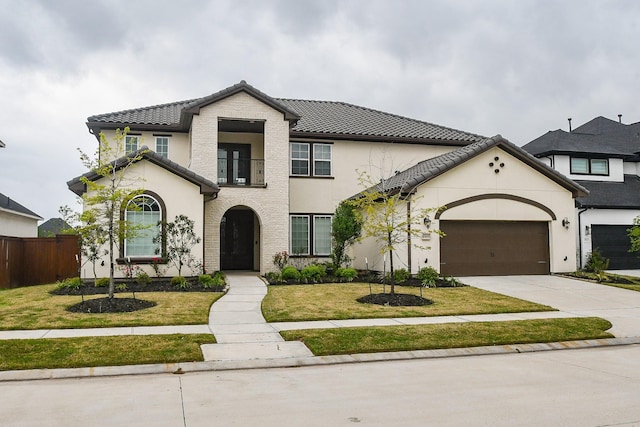 6939 Shoreline View Dr, Katy, TX 77493 - mediterranean / spanish home with fence, a garage, a front yard, concrete driveway, and a balcony