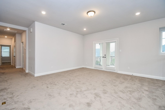6939 Shoreline View Dr, Katy, TX 77493 - spare room featuring carpet floors, baseboards, visible vents, and french doors