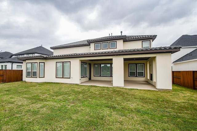 6939 Shoreline View Dr, Katy, TX 77493 - back of house featuring a fenced backyard, a patio, stucco siding, and a lawn