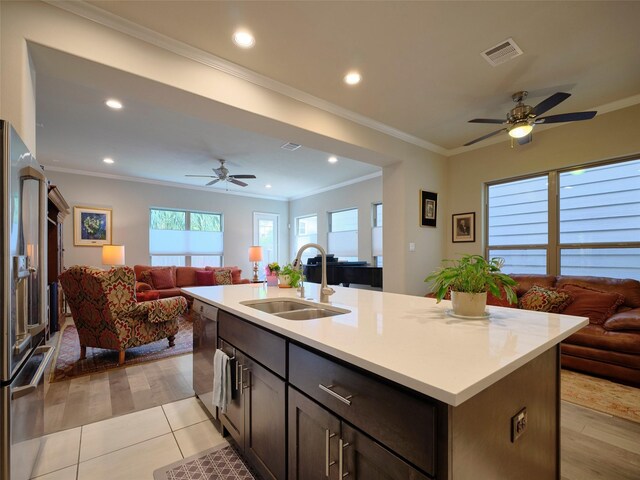 kitchen featuring visible vents, a ceiling fan, open floor plan, a sink, and appliances with stainless steel finishes