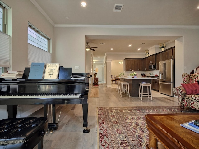 5235A Petty St, Houston, TX 77007 - living area featuring ornamental molding, light wood finished floors, a ceiling fan, and recessed lighting