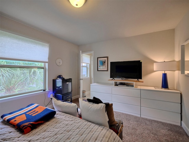 carpeted bedroom with baseboards