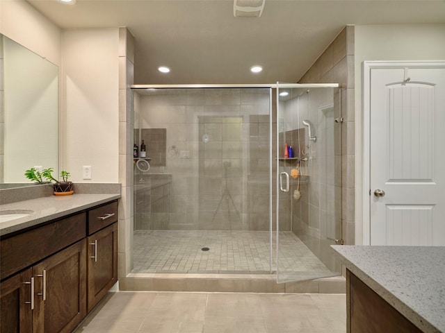 full bathroom with vanity, tile patterned floors, a stall shower, and recessed lighting