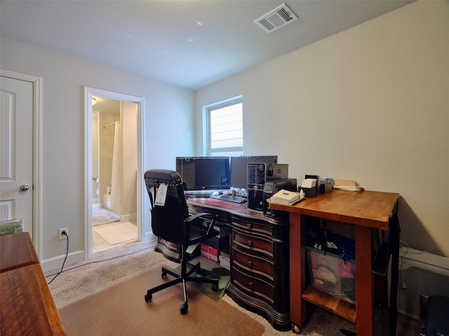 office area featuring carpet floors, baseboards, and visible vents