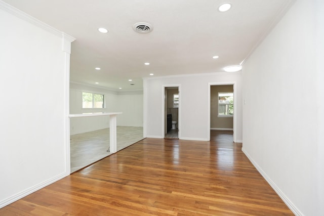 5714 Nina Lee Ln, Houston, TX 77092 - empty room featuring ornamental molding, healthy amount of natural light, recessed lighting, light wood-style floors, and baseboards