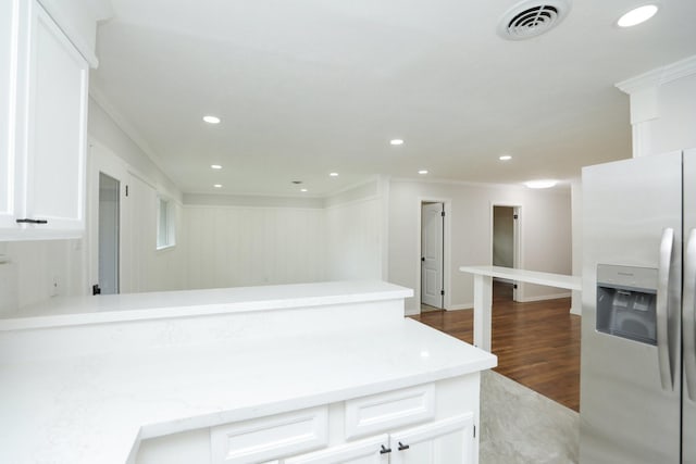 5714 Nina Lee Ln, Houston, TX 77092 - kitchen with stainless steel fridge with ice dispenser, ornamental molding, white cabinets, a peninsula, and dark wood finished floors