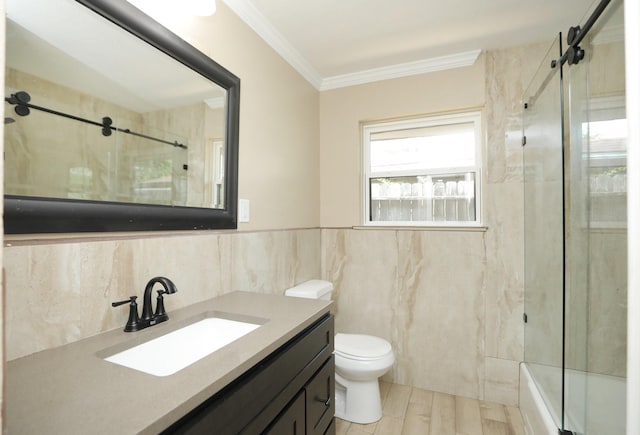 5714 Nina Lee Ln, Houston, TX 77092 - bathroom with tile walls, toilet, ornamental molding, vanity, and combined bath / shower with glass door