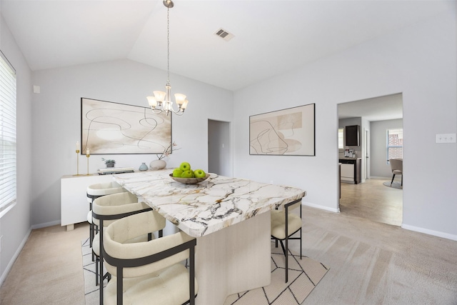 dining space featuring visible vents, plenty of natural light, a notable chandelier, and light carpet