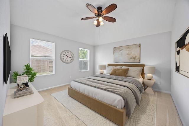 bedroom featuring ceiling fan, baseboards, and light carpet