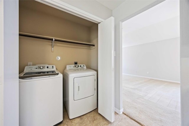 laundry area featuring baseboards, light carpet, laundry area, and washing machine and dryer