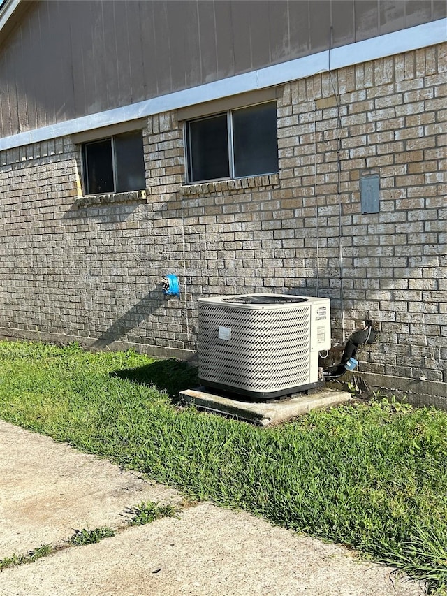 details with central air condition unit and brick siding