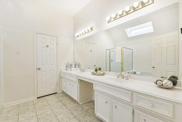 bathroom featuring a stall shower, vanity, tile patterned floors, baseboards, and lofted ceiling with skylight