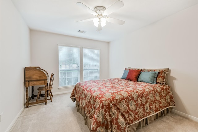 bedroom featuring baseboards, light carpet, a ceiling fan, and visible vents