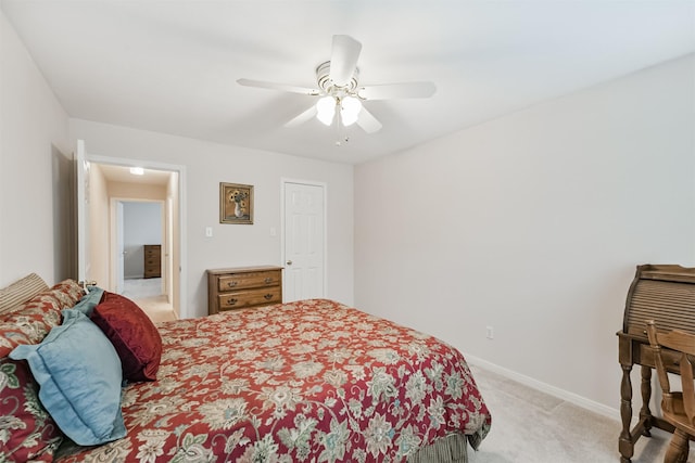 bedroom with baseboards, ceiling fan, and light colored carpet