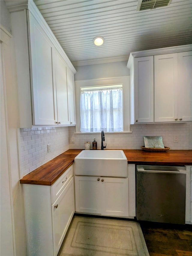 kitchen with butcher block countertops, a sink, decorative backsplash, and dishwasher