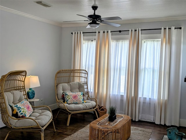 sitting room featuring crown molding, dark wood-style flooring, a ceiling fan, baseboards, and visible vents