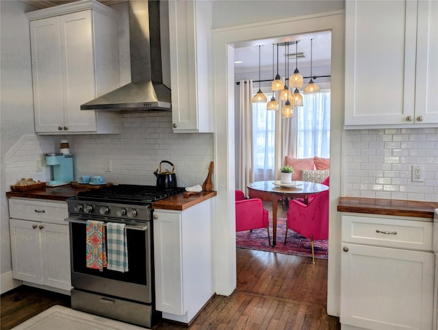 kitchen featuring a notable chandelier, stainless steel gas range oven, wooden counters, wall chimney exhaust hood, and dark wood-style floors