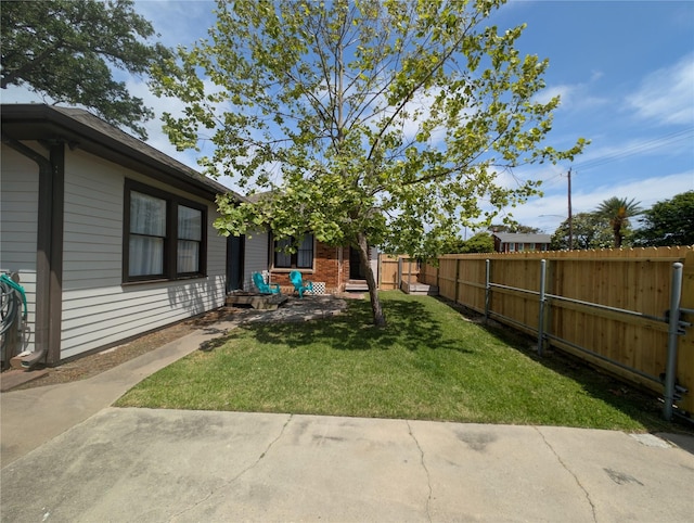 view of yard with a patio and a fenced backyard