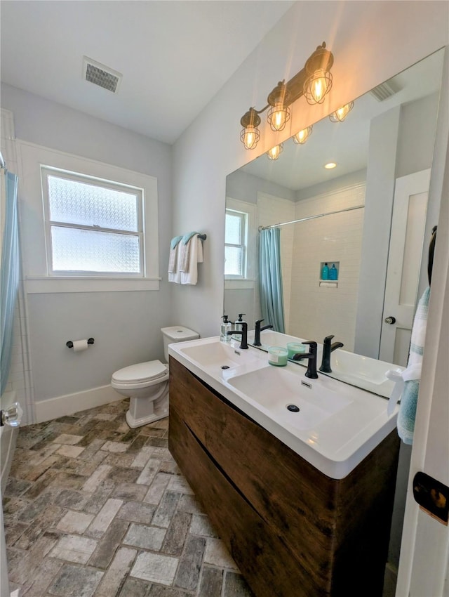 bathroom with visible vents, baseboards, toilet, and a shower with curtain