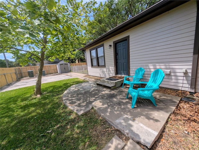 view of patio / terrace with an outdoor structure, a fenced backyard, and a shed
