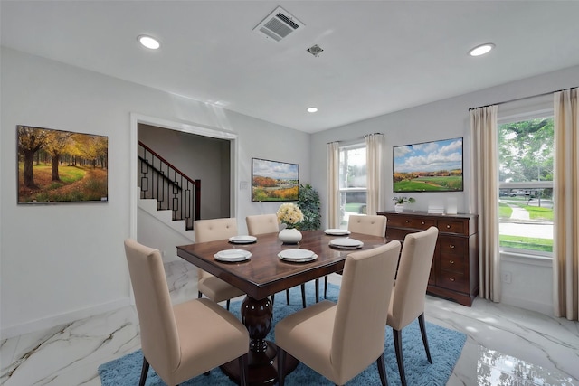 dining space featuring visible vents, a healthy amount of sunlight, and marble finish floor