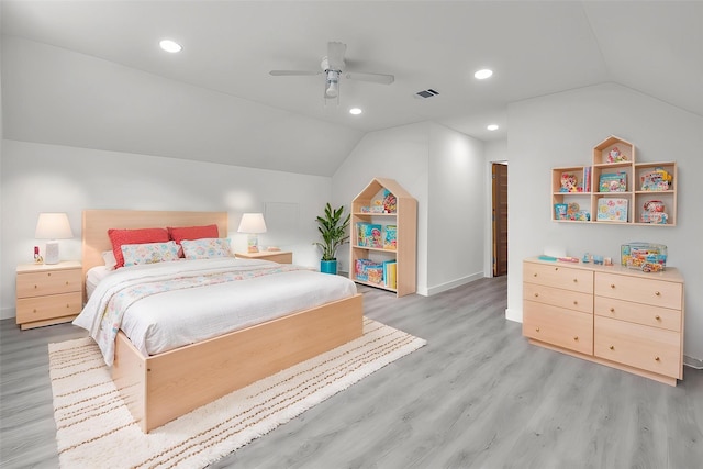 bedroom featuring baseboards, visible vents, lofted ceiling, and light wood-style floors