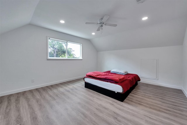 bedroom featuring baseboards, vaulted ceiling, recessed lighting, and wood finished floors