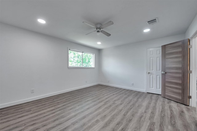 unfurnished room featuring ceiling fan, recessed lighting, wood finished floors, and visible vents