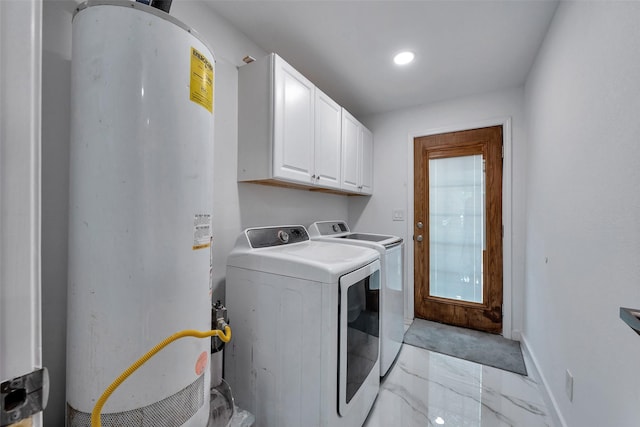 laundry room featuring cabinet space, independent washer and dryer, gas water heater, marble finish floor, and baseboards